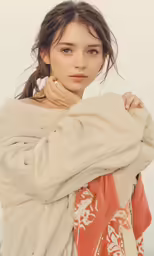a woman is holding onto her coat as she poses for a portrait