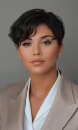 a woman posing for a portrait with short hair