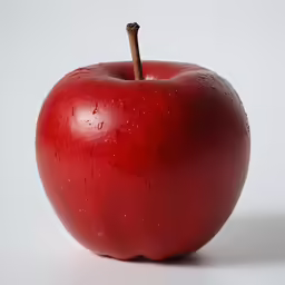 a close up of an apple with drops of rain on it