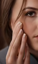closeup of woman putting on makeup