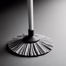 a small silver and black candle on a light