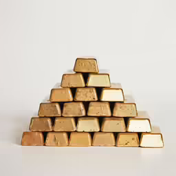 a pyramid shaped like gold bars against a white background