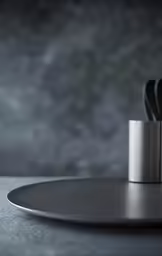 a plate and several knives are stacked on top of each other