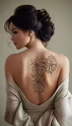 a woman with a black and white tattoo on her back