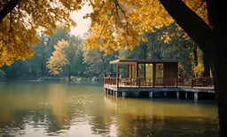 a small boathouse next to a pier in a lake