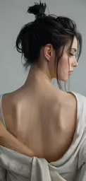 the back view of a woman in white draped fabric