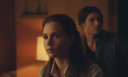man and woman facing away in the bedroom