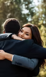 two people hug each other and laugh together