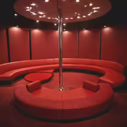 a circular couch and bench in a modern theater