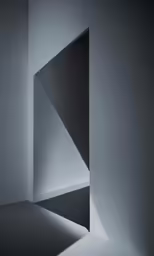 an abstract white wall in the middle of a room