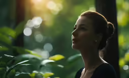 a woman with earrings standing in the middle of the woods