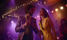 a man and woman dance on a stage