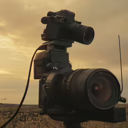 an electronic camera is set on top of a tripod