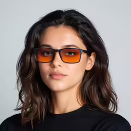 a woman wearing black sunglasses with an orange mirrored lens