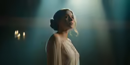 woman dressed up in light and with head tilted to side