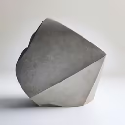 an irregular sculpture made out of concrete on the white background