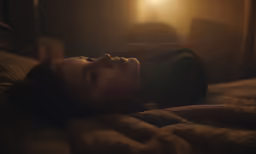 a person laying down with their eyes closed