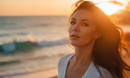 an attractive woman looking at the camera on the beach