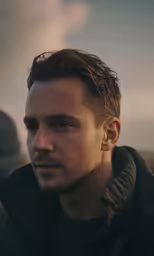 a man is standing outside in the sun
