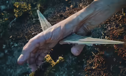 an image of a man holding a pair of scissors