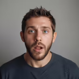 a man with an unbuttoned beard and blue eyes