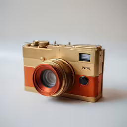 an old camera on white background with a red lens