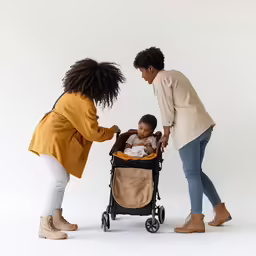 three woman pushing a baby in a stroller