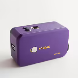 a purple camera is on display against a white background