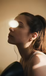 a woman that has the light up and is wearing earrings