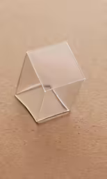 a close up of a glass object sitting on a surface