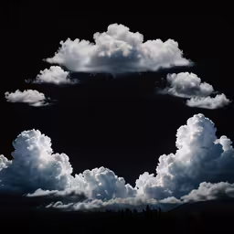 a photograph of an image of clouds in the sky,a bunch of white clouds are in the dark