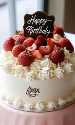this is a birthday cake with strawberries and whipped cream