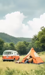 van parked in a field with a tent, campervan and camper