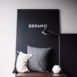 the pillows on the bed is the color of the pillow and the wall is black