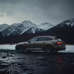 a car parked in the snow near some mountains