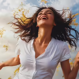 a woman holding her arms up to the sky