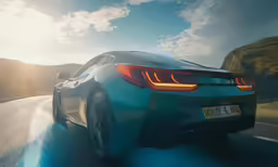 a sports car driving on a curved highway