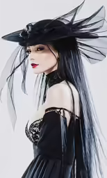 woman in dark clothes and a black hat