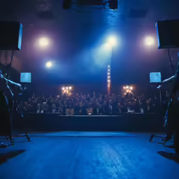 an auditorium with several lighting equipment and audience