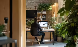a man sitting at a desk working on a computer