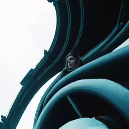 a woman standing in front of the big pipes