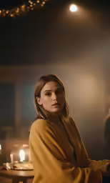 a woman standing in a dimly lit room