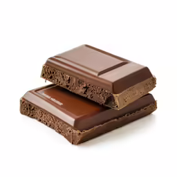 a piece of chocolate covered dessert is stacked on top of another
