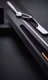 scissors, silverware and smart device on a table