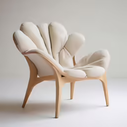 an unusual chair sits in front of a white background