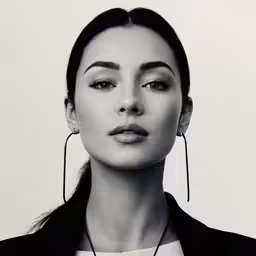 the model wears the long metal statement necklace