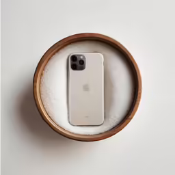 an iphone in a case is sitting on a shelf