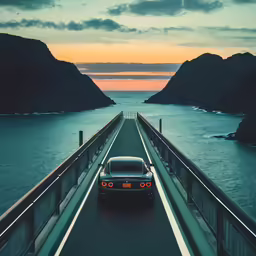 a car is traveling down a bridge to the ocean