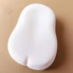 a white cushion shaped like an oval