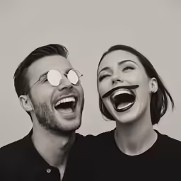 the man and woman are both wearing fake toothy mouths